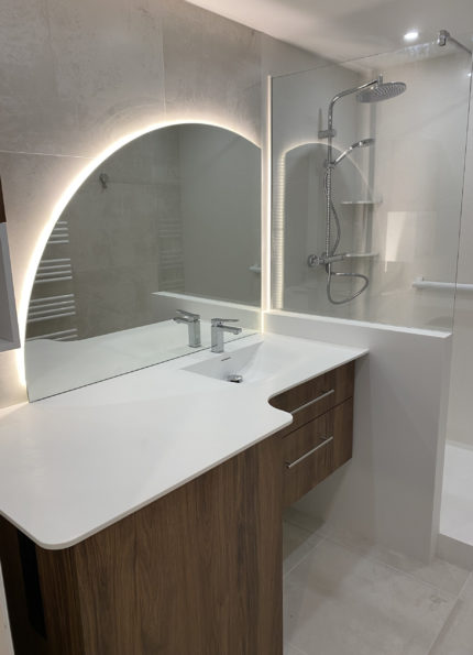Plan vasque en résine Krion avec vasque Souplesse et meuble mélaminé décor bois, conçu et installé sur mesure.